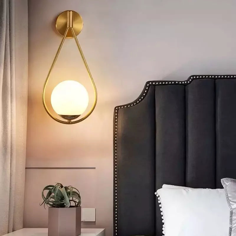 Modern Gold - Accented Indoor LED Wall Sconce Light. Features a glass ball bubble design, perfect for bedroom bedside, hotel, living, and sitting rooms.