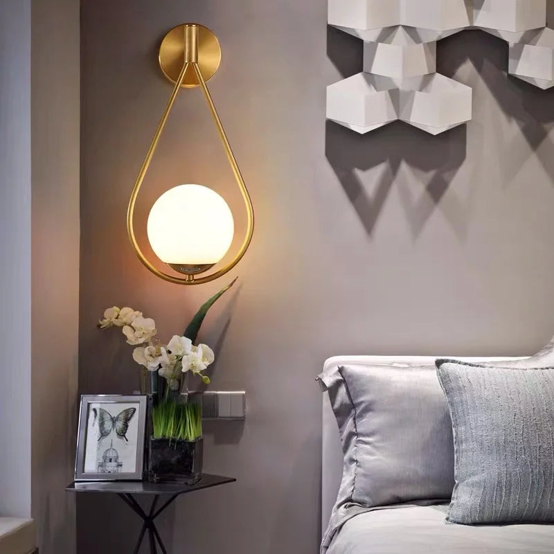 Modern Gold - Accented Indoor LED Wall Sconce Light. Features a glass ball bubble design, perfect for bedroom bedside, hotel, living, and sitting rooms.