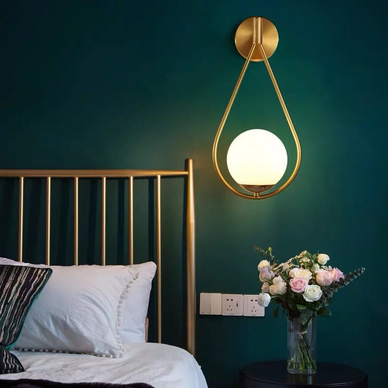 Modern Gold - Accented Indoor LED Wall Sconce Light. Features a glass ball bubble design, perfect for bedroom bedside, hotel, living, and sitting rooms.
