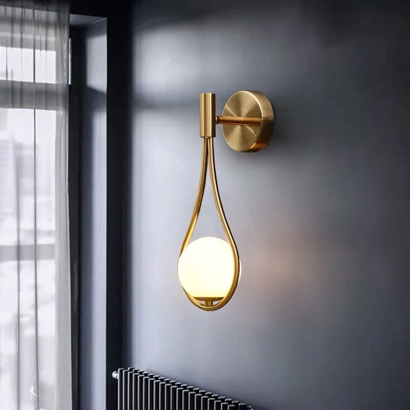 Modern Gold - Accented Indoor LED Wall Sconce Light. Features a glass ball bubble design, perfect for bedroom bedside, hotel, living, and sitting rooms.