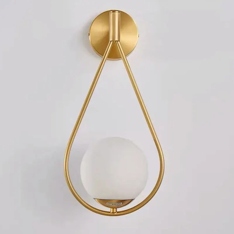 Modern Gold - Accented Indoor LED Wall Sconce Light. Features a glass ball bubble design, perfect for bedroom bedside, hotel, living, and sitting rooms.